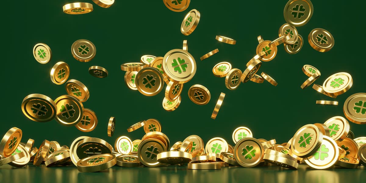 A shower of golden coins with a four-leaf shamrock