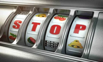 Slot machine spelling out letters STOP in red